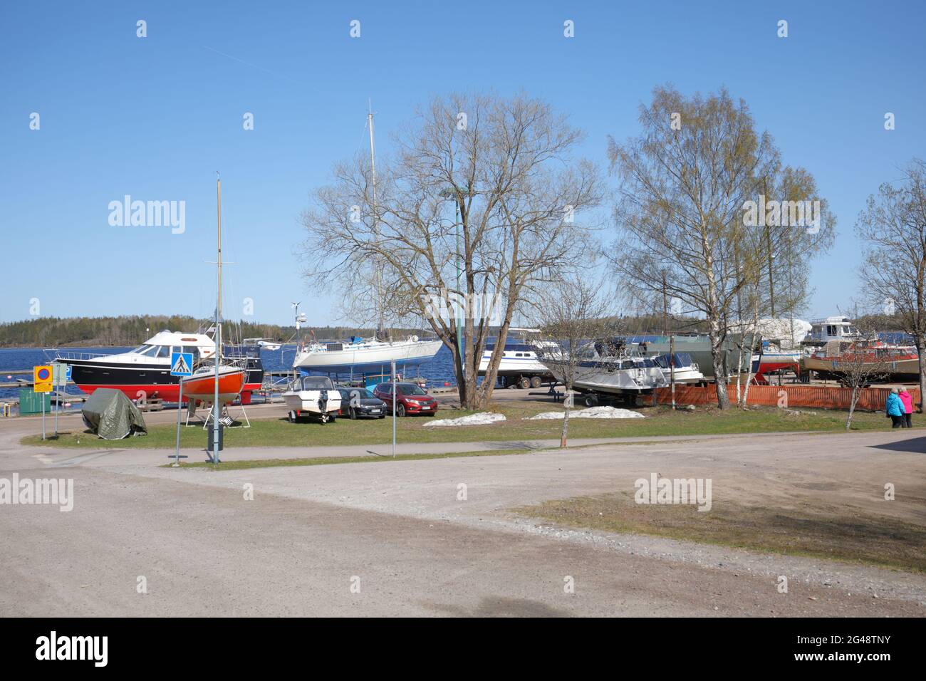 Boats prepared to new season on the shore of lake Saimaa in Lappeenranta, Finland, in a sunny springtime day Stock Photo