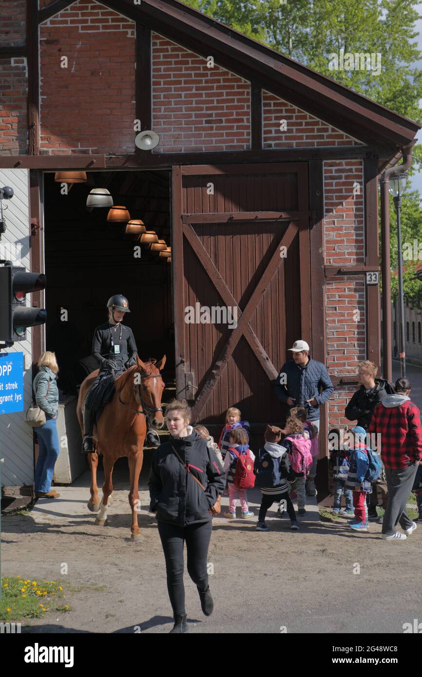 Equestrian and people with children at the riding hall in Myntgata street in Oslo, Norway Stock Photo