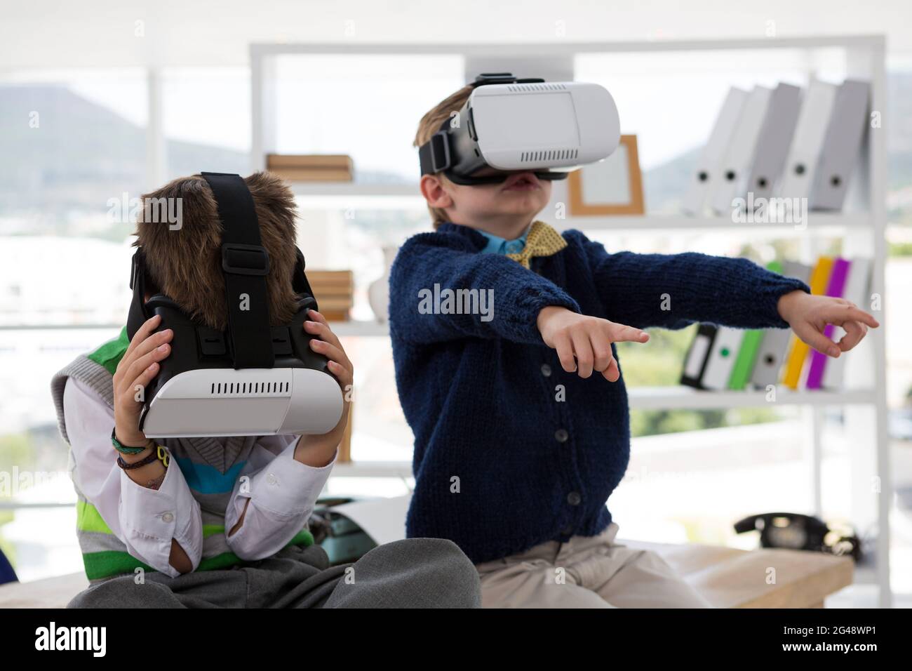 Kids as business executives using virtual reality headset Stock Photo