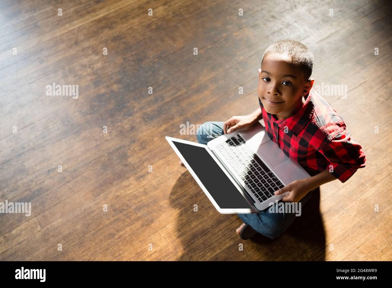 Portrait of cute boy using laptop Stock Photo - Alamy
