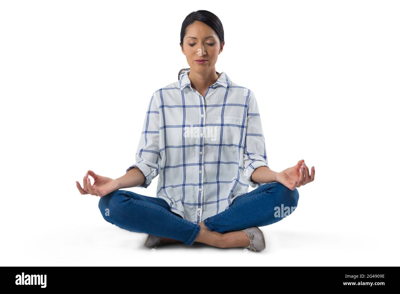 Woman performing yoga against white background Stock Photo - Alamy