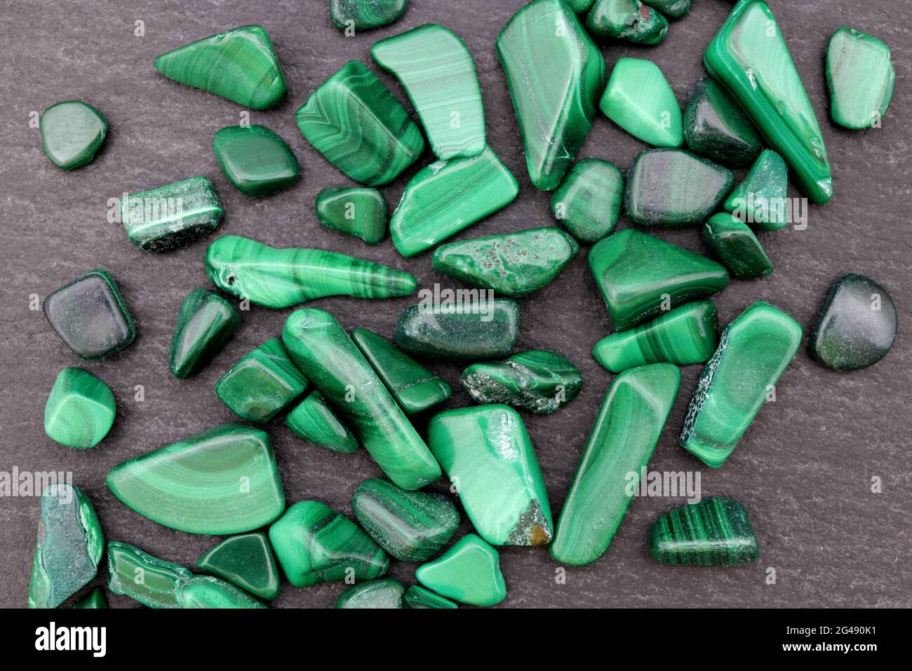 Malachite heap up jewel stones texture on black stone background