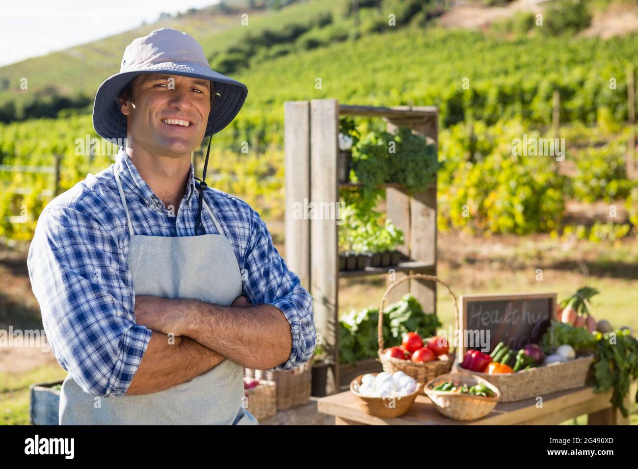 Portrait of farmer standing with arms crossed Stock Photo - Alamy