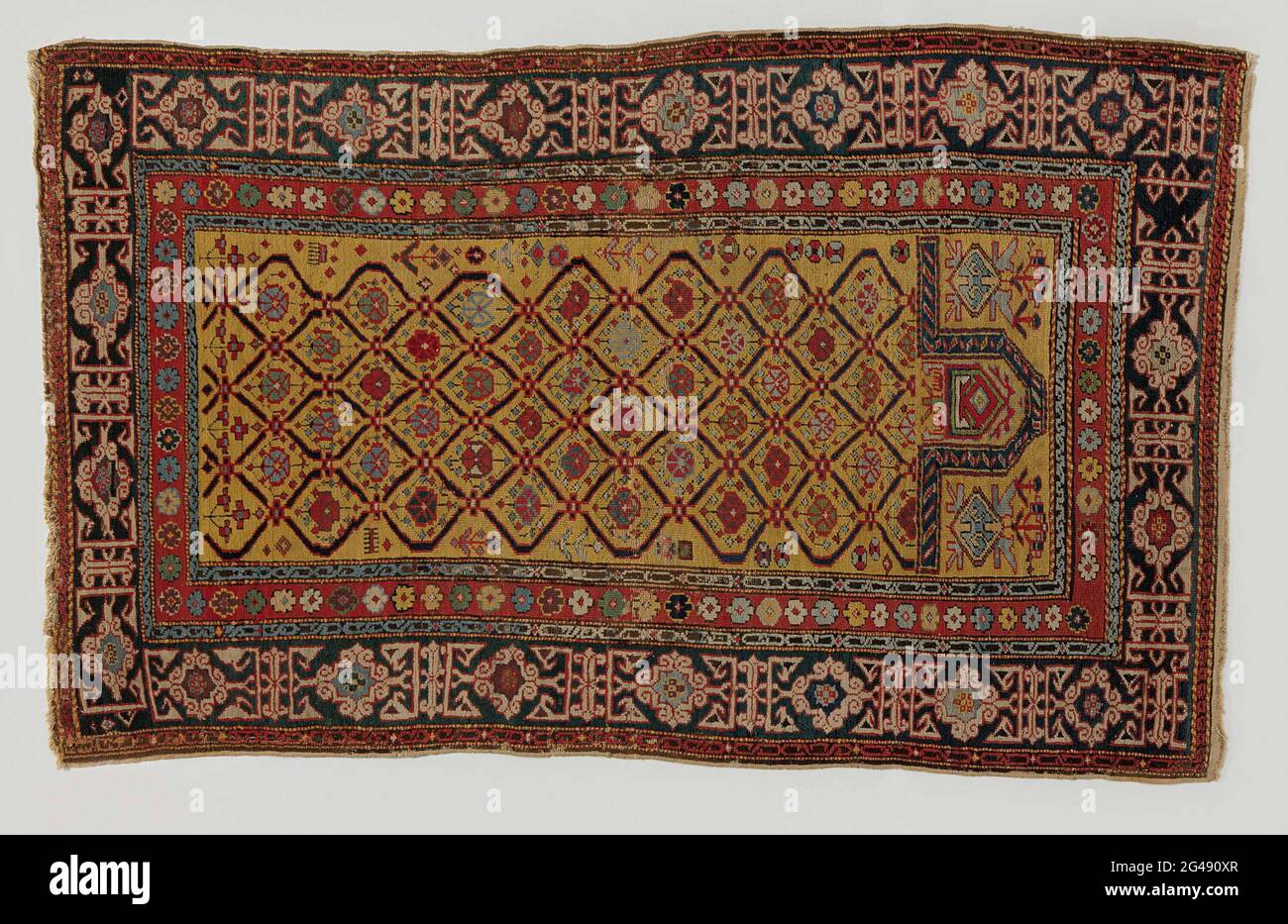 Oriental carpet. Oriental carpet, prayer dress. In midfield a golden yellow mihrab with a brown