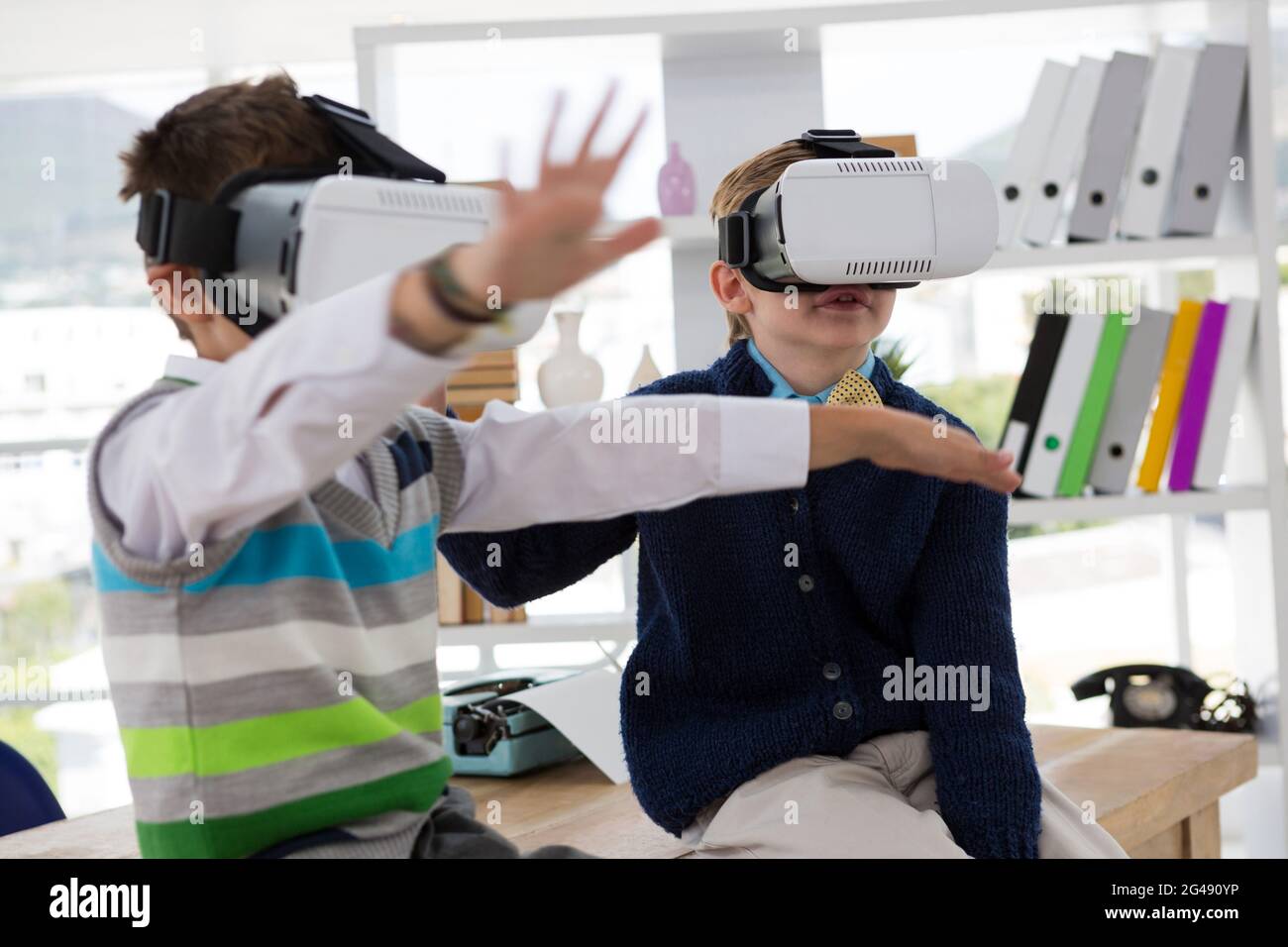 Kids as business executives using virtual reality headset Stock Photo