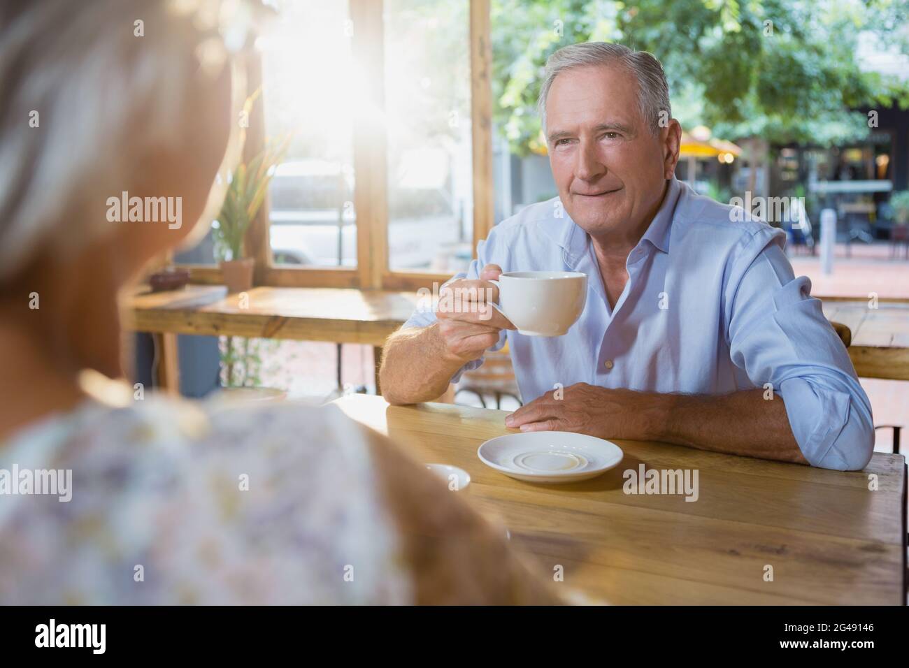 Senior couple interacting while having coffee Stock Photo