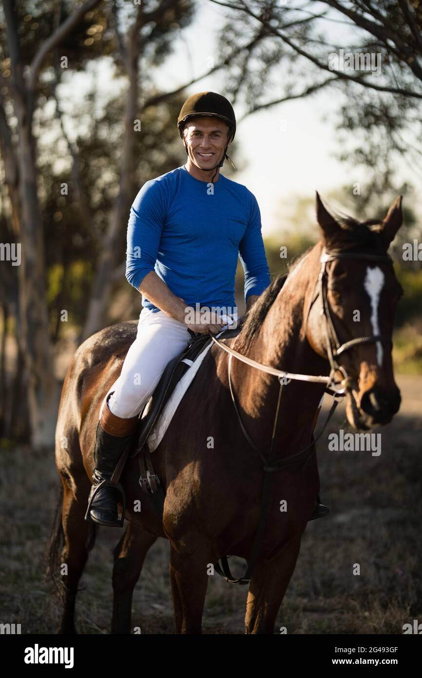 Portrait of male jockey riding horse Stock Photo