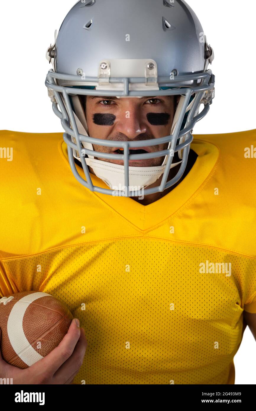 Portrait of determined American football player wearing helmet holding