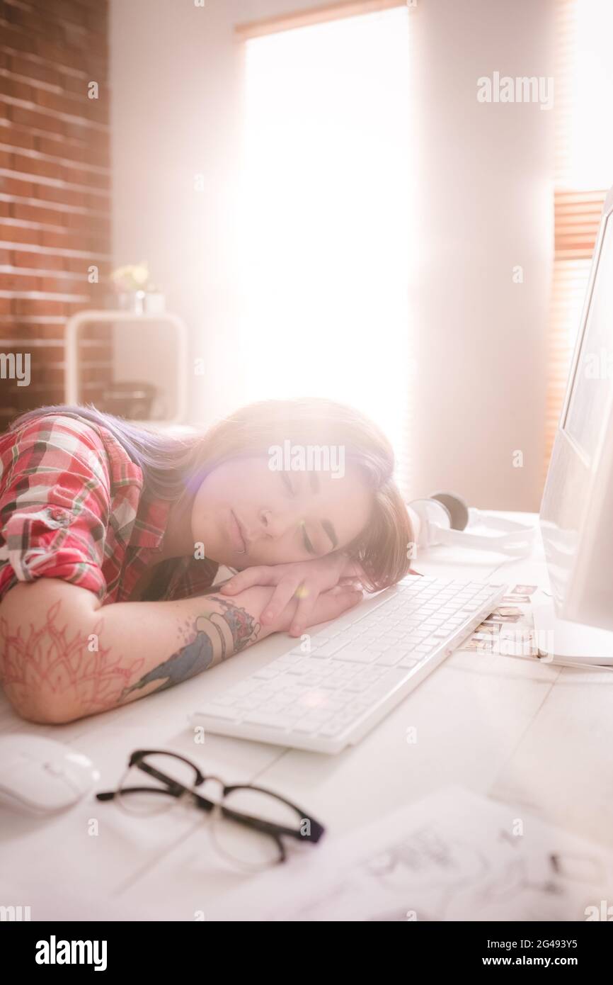 Female executive sleeping at her desk Stock Photo - Alamy