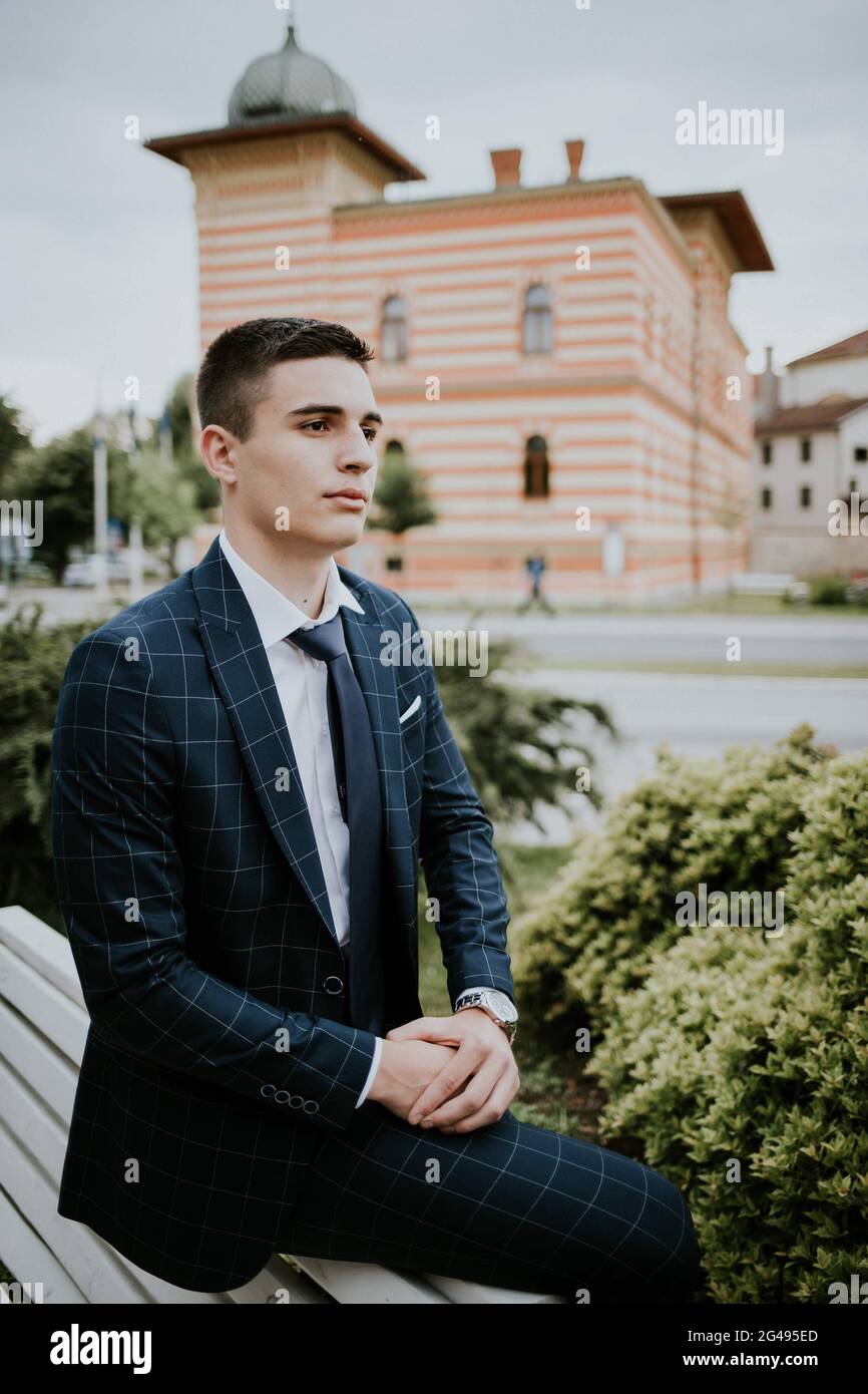Caucasian young businessman in a suit and tie sitting outdoor Stock ...
