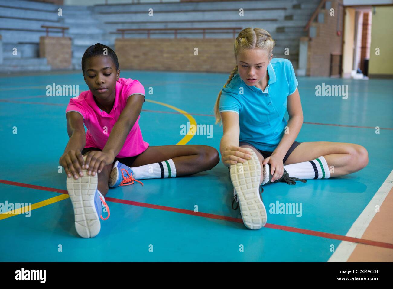 Volleyball players performing stretching exercise Stock Photo Alamy