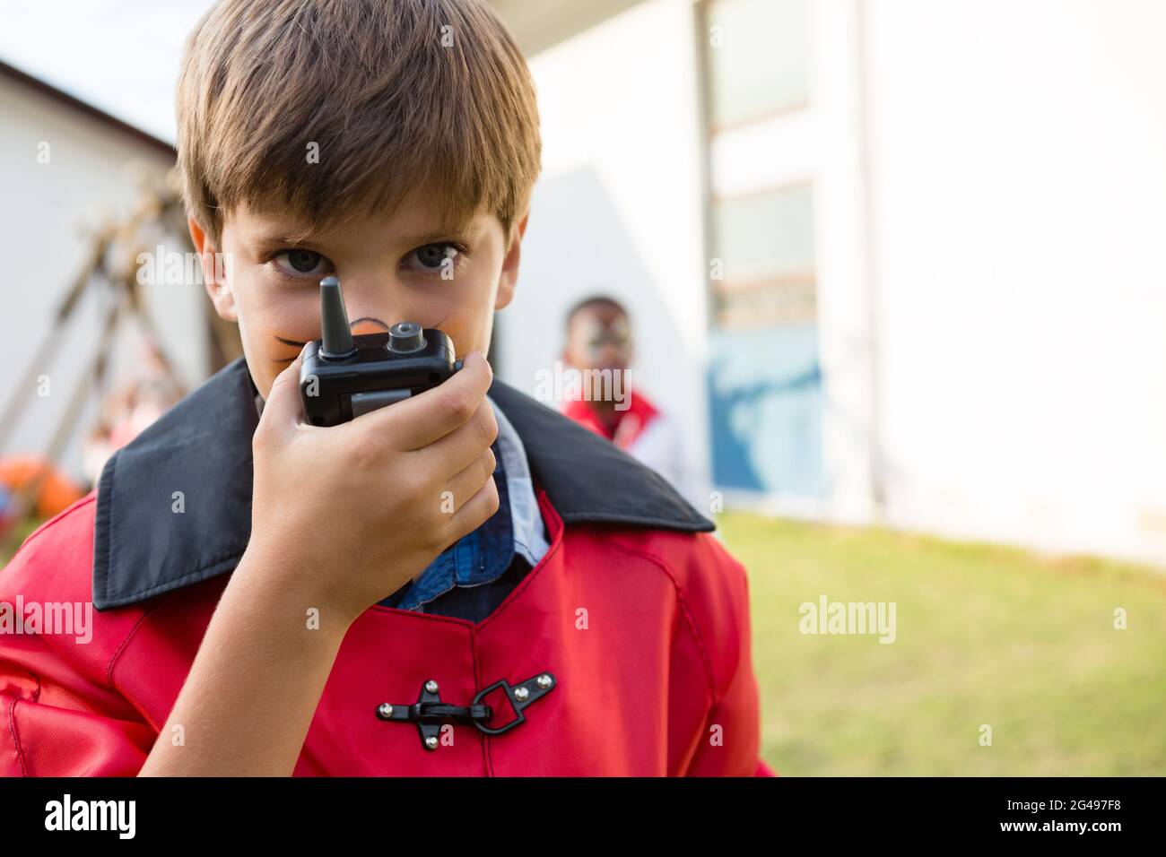Portrait of boy with face paint using walkie talkie Stock Photo