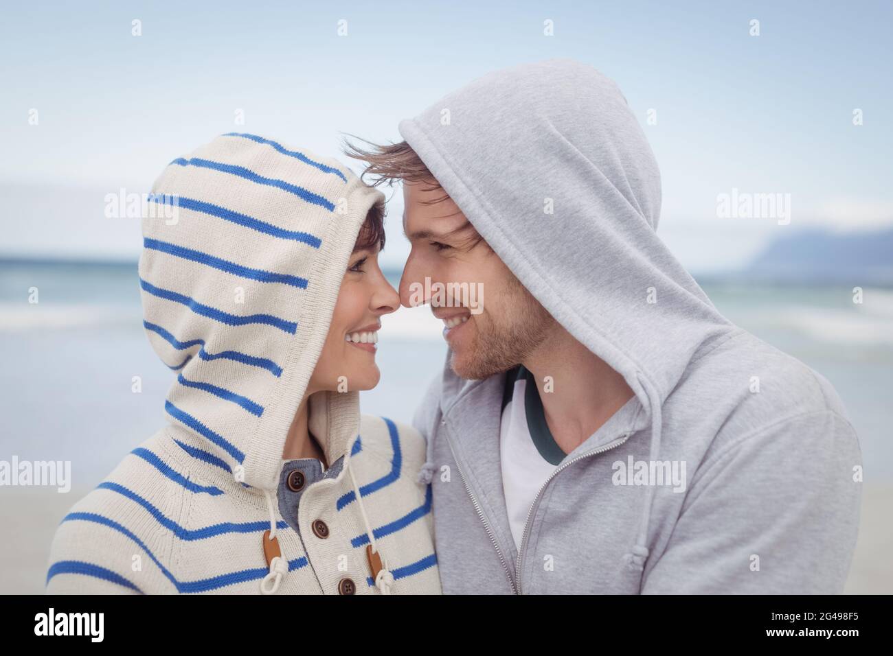 Smiling couple wearing hooded sweater during winter Stock Photo