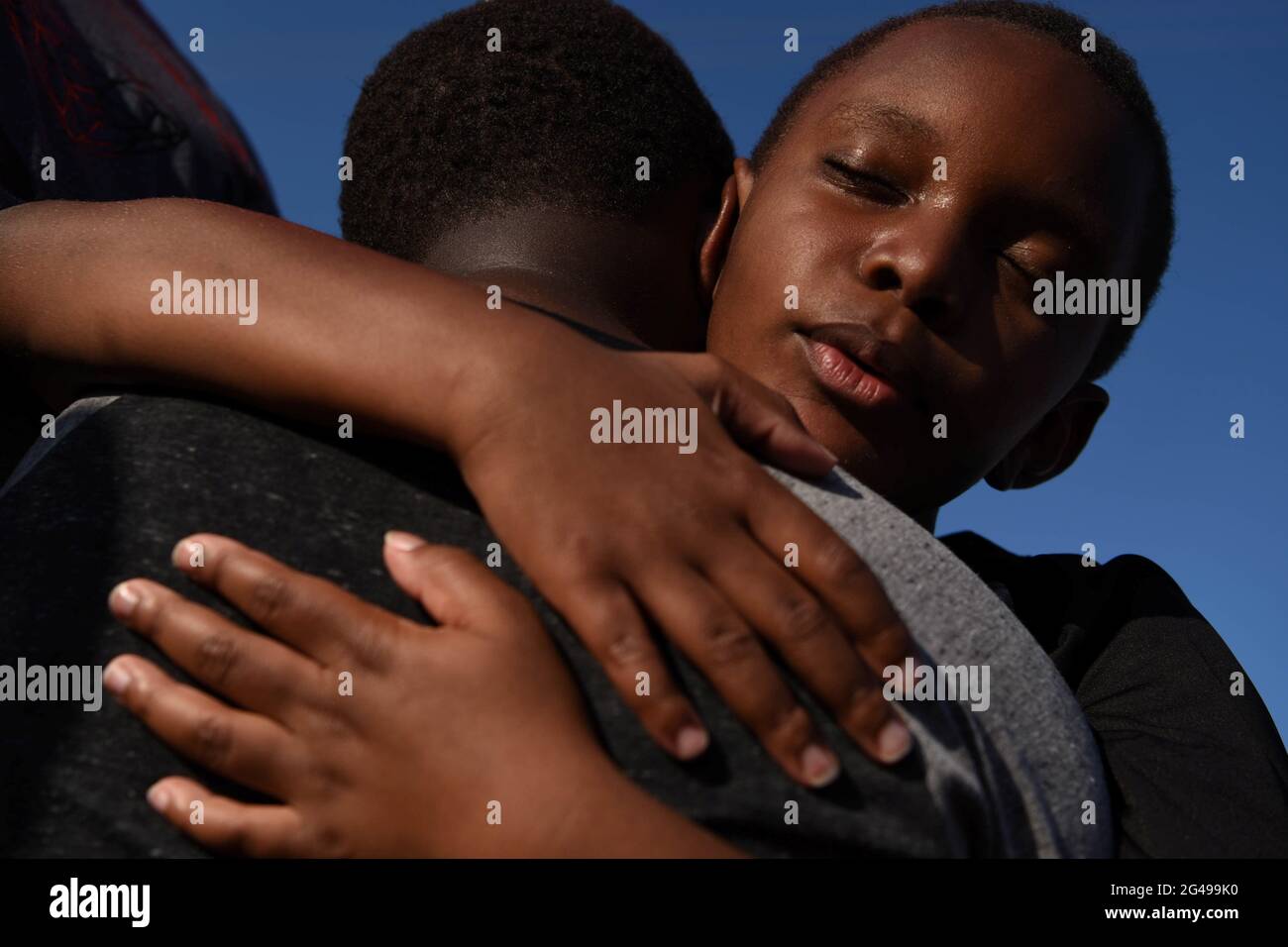 Brothers Brody and Braeden Maxey share a hug during a reenactment to
