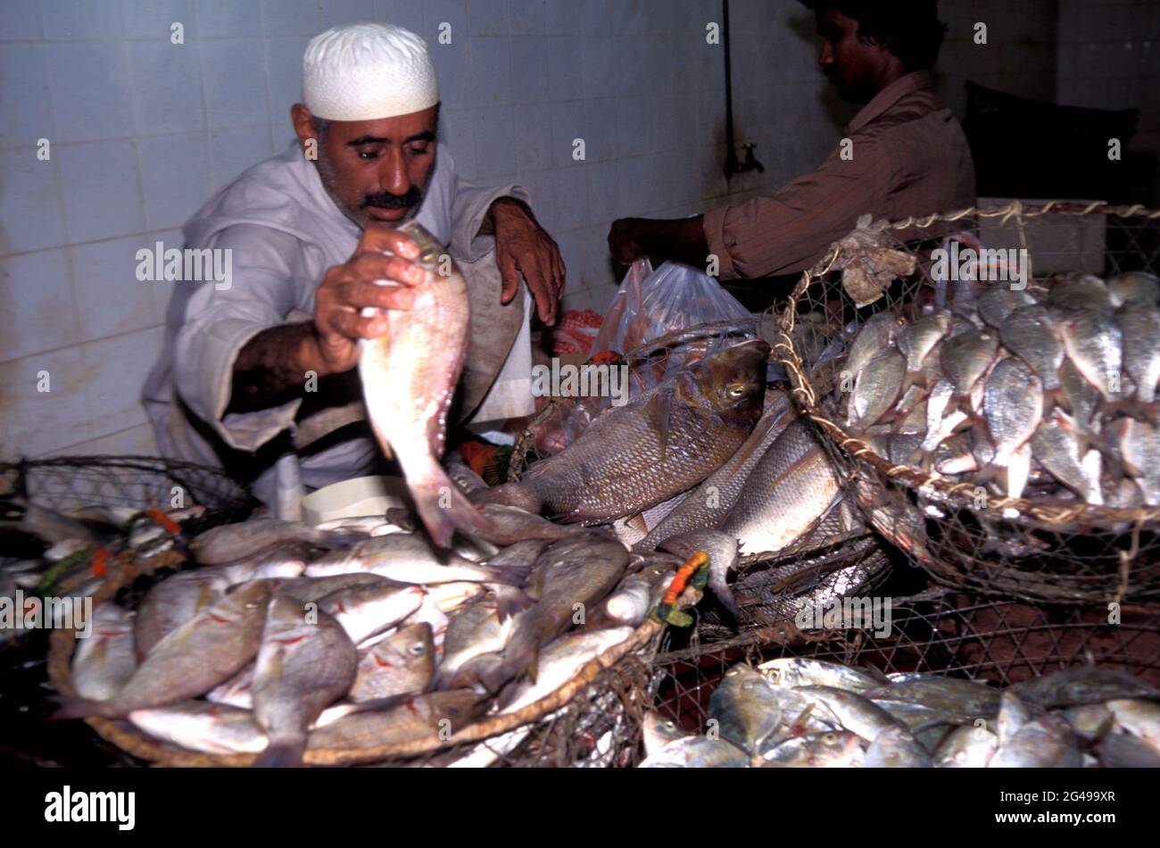 Trader with a basket of freshly caught fish, Doha Fish Market, Qatar