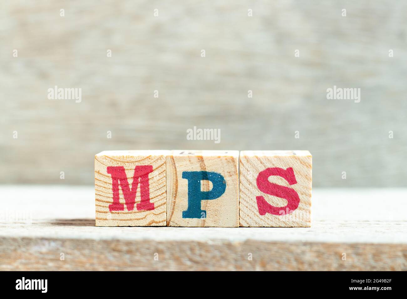 Alphabet letter block in word MPS (Abbreviation of Master Production Schedule or Mucopolysaccharidosis) on wood background Stock Photo