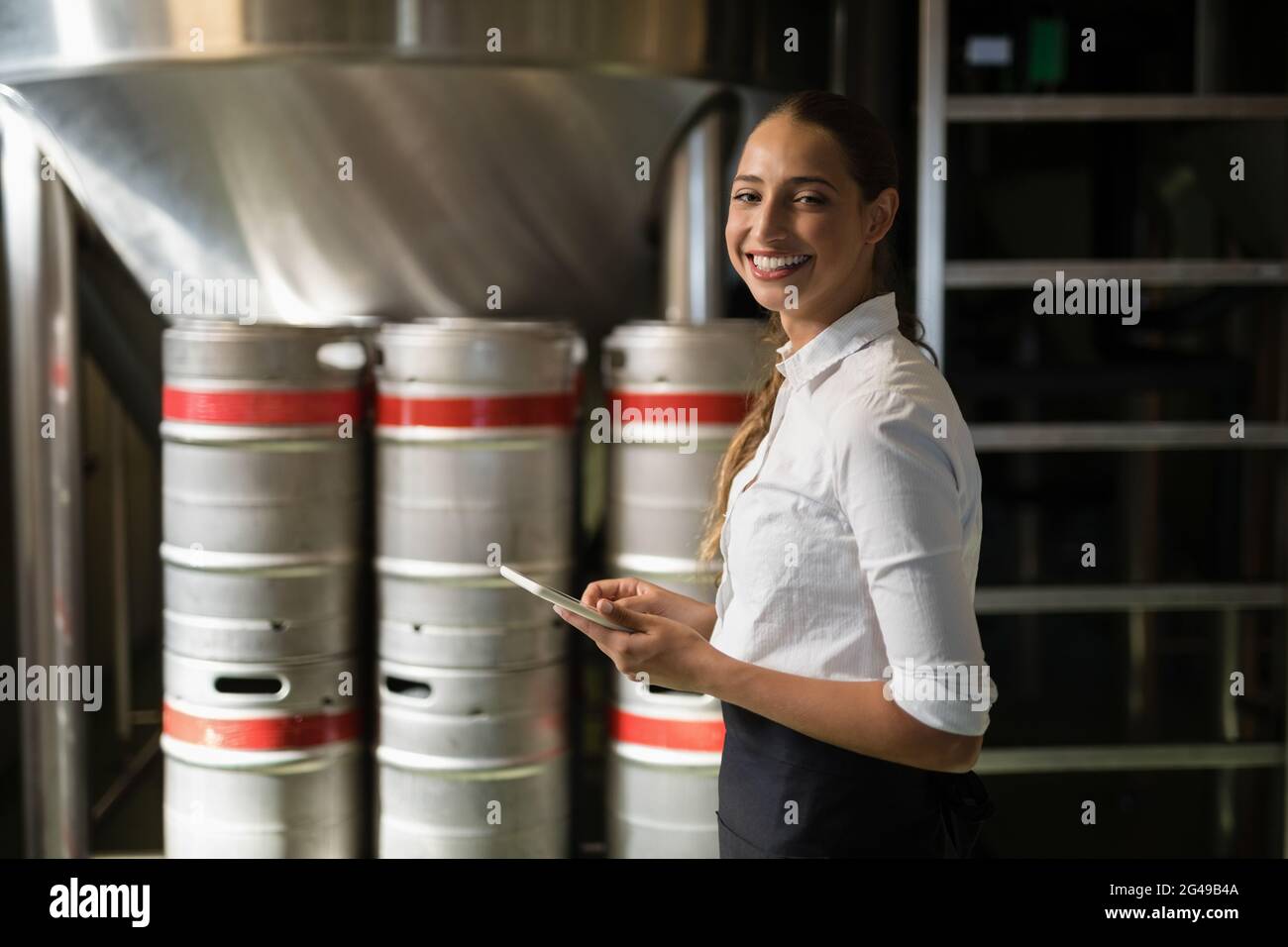 Smiling waitress using digital tablet in bar Stock Photo