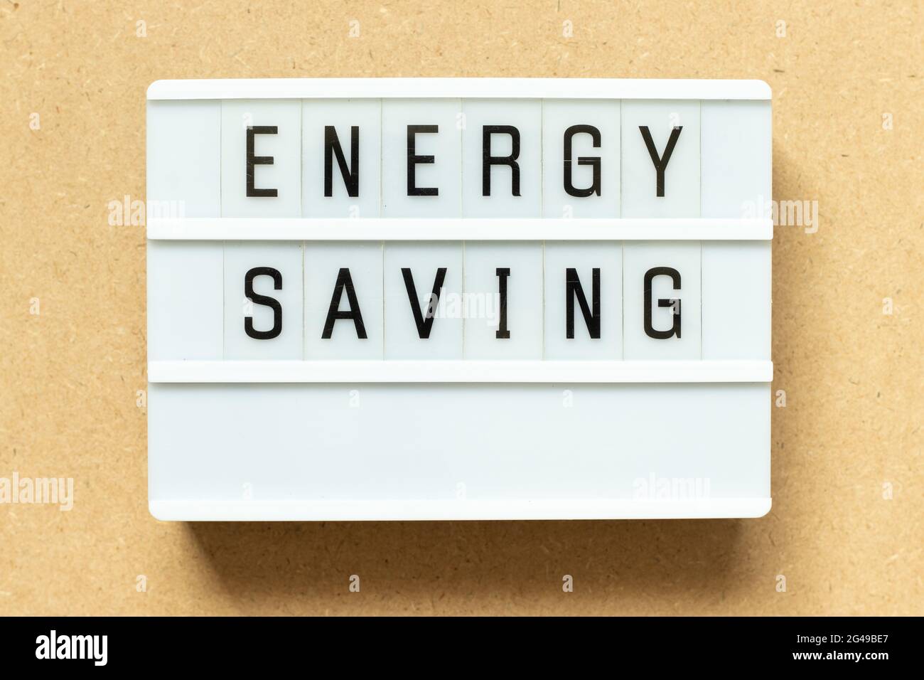 Lightbox with word energy saving on wood background Stock Photo