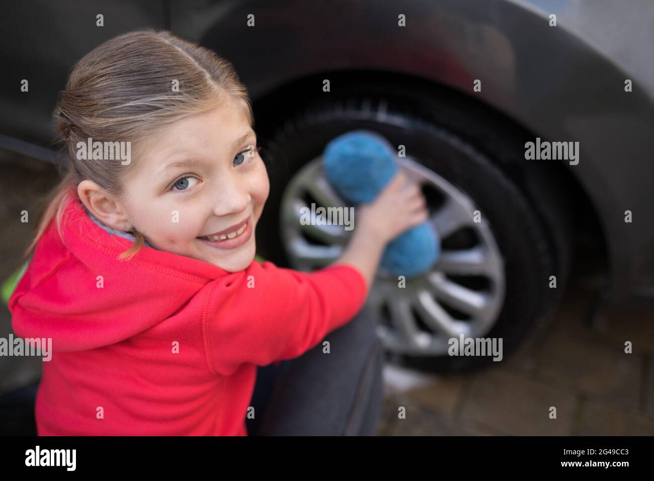 Teenage girl washing a car on a sunny day Stock Photo Alamy