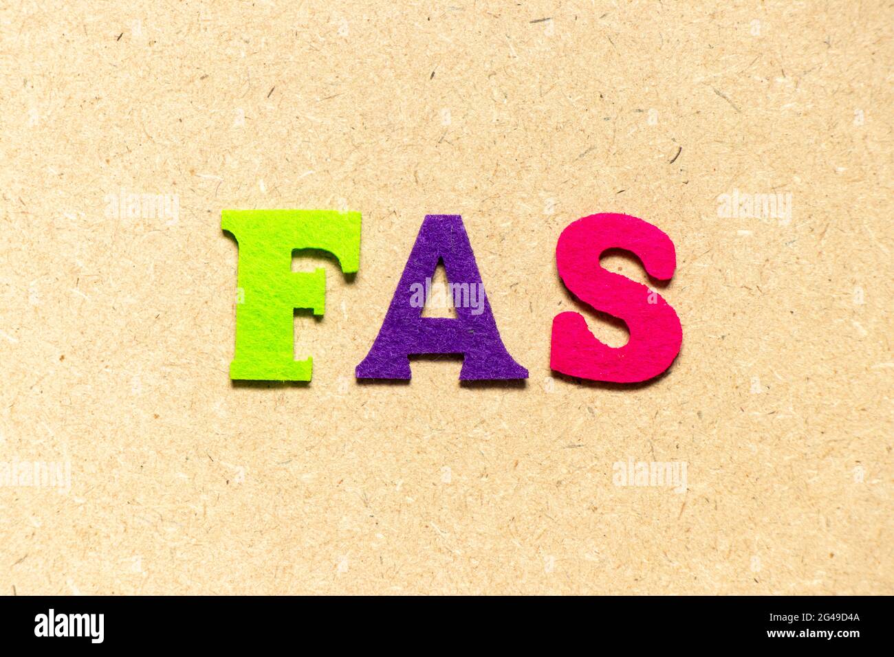 Color cloth alphabet letter in word FAS (Abbreviation of Fetal alcohol syndrome, Free alongside or Financial accounting standards) on wood background Stock Photo