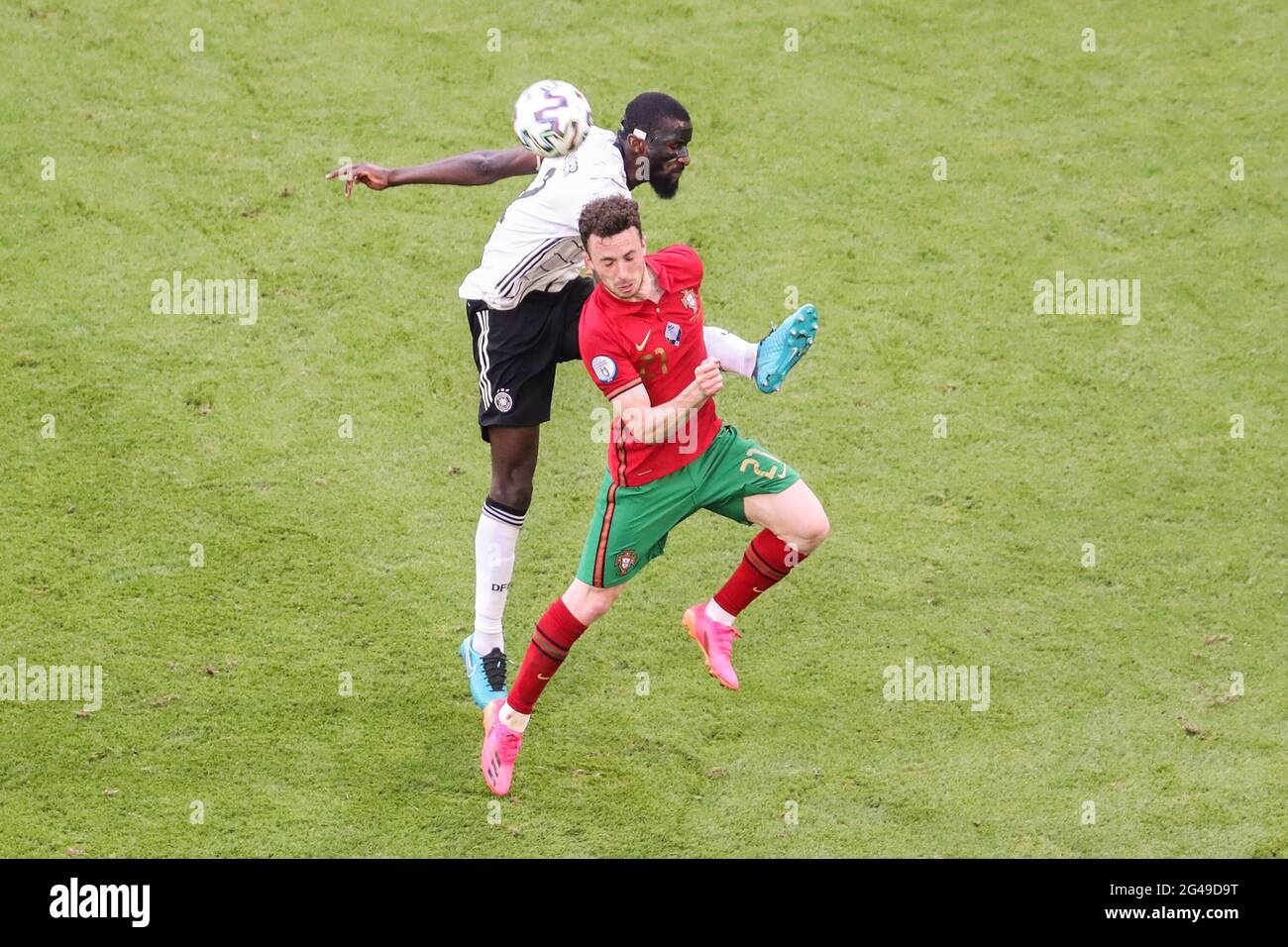 Munich, Germany. 19th June, 2021. Antonio Ruediger (up) of Germany vies with Diogo Jota of Portugal during the UEFA Euro 2020 Championship Group F match in Munich, Germany, June 19, 2021. Credit: Shan Yuqi/Xinhua/Alamy Live News Stock Photo
