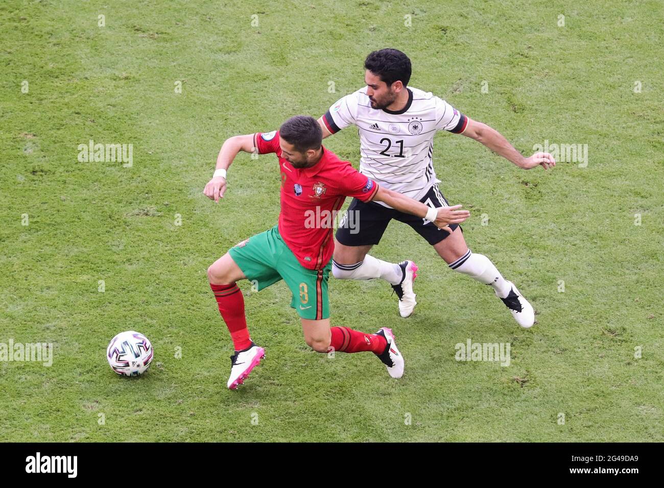 Munich, Germany. 19th June, 2021. Ilkay Guendogan (R) of Germany vies with Joao Moutinho of Portugal during the UEFA Euro 2020 Championship Group F match in Munich, Germany, June 19, 2021. Credit: Shan Yuqi/Xinhua/Alamy Live News Stock Photo