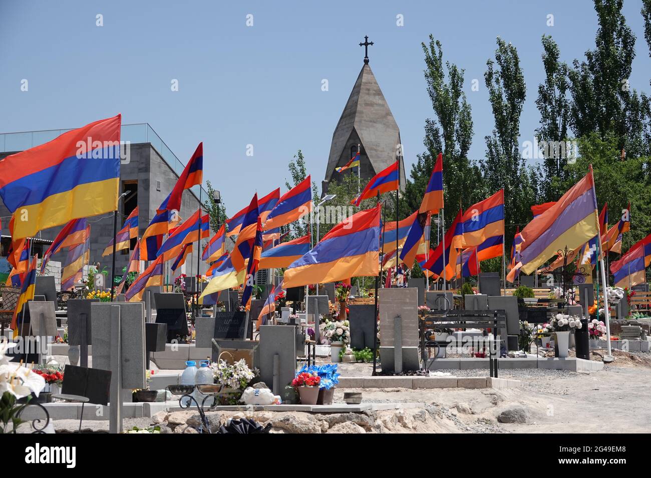 Eriwan, Armenia. 19th June, 2021. The graves of Armenian soldiers who died in the autumn war with Azerbaijan over the conflict region of Nagorno-Karabakh, in the city's military cemetery. Seven months after the war, the crisis-ridden South Caucasus republic of Armenia holds an early parliamentary election on June 20, 2021. Credit: Ulf Mauder/dpa/Alamy Live News Stock Photo
