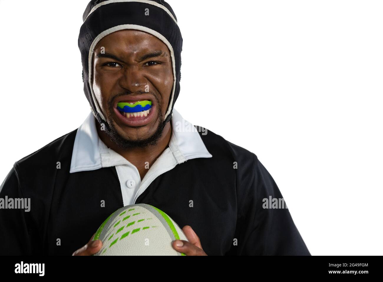 Portrait of male rugby player wearing mouthguard white holding
