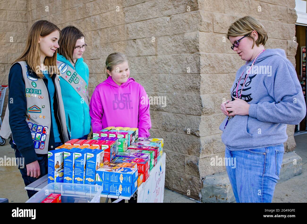 Girl Scouts sell Girl Scout Cookies to a customer outside Walmart, Feb. 24, 2013, in Columbus, Mississippi. Stock Photo