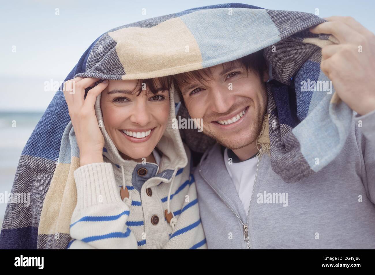 Portrait of smiling couple with blanket during winter Stock Photo