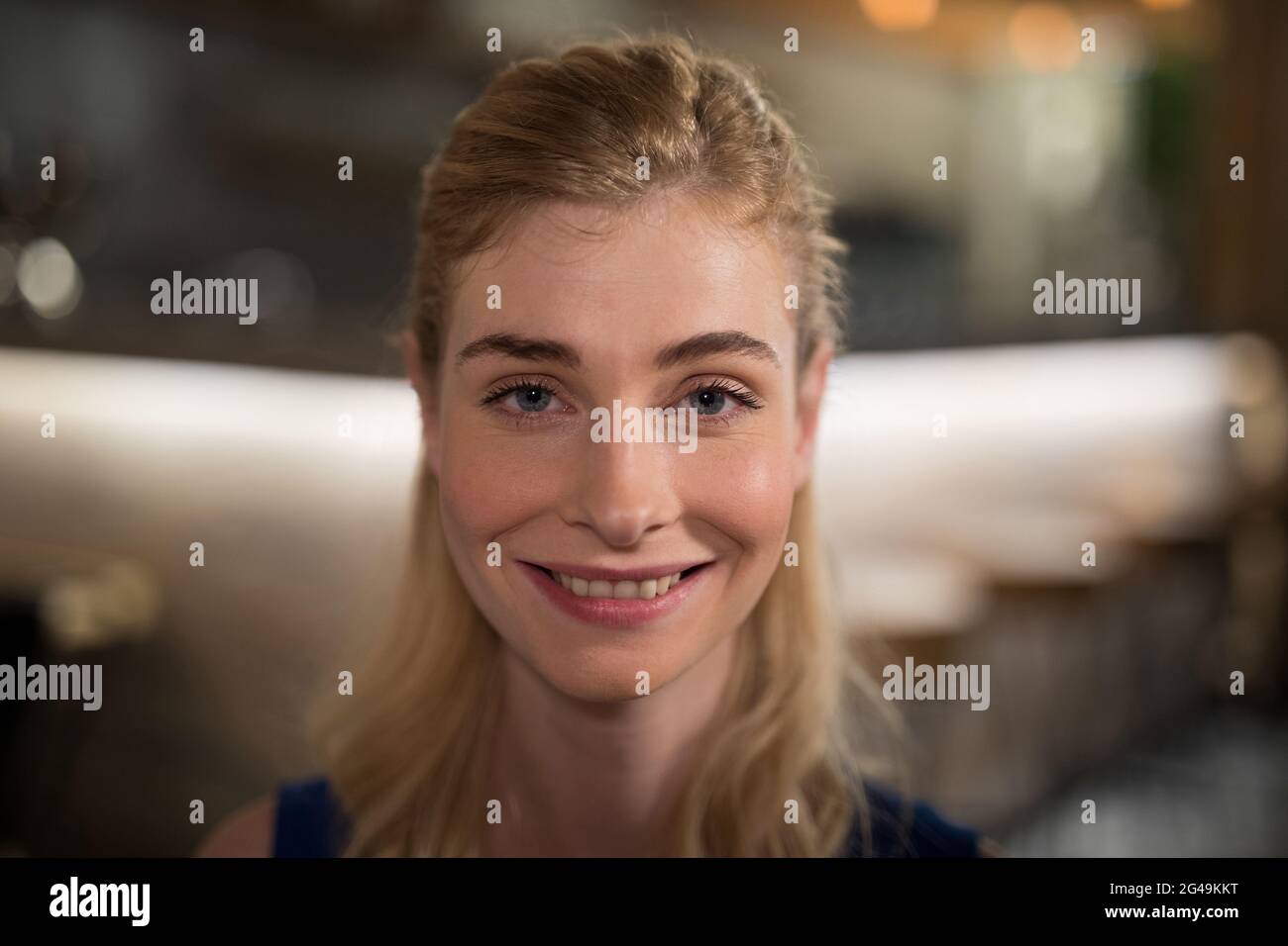 Happy woman sitting in restaurant Stock Photo - Alamy