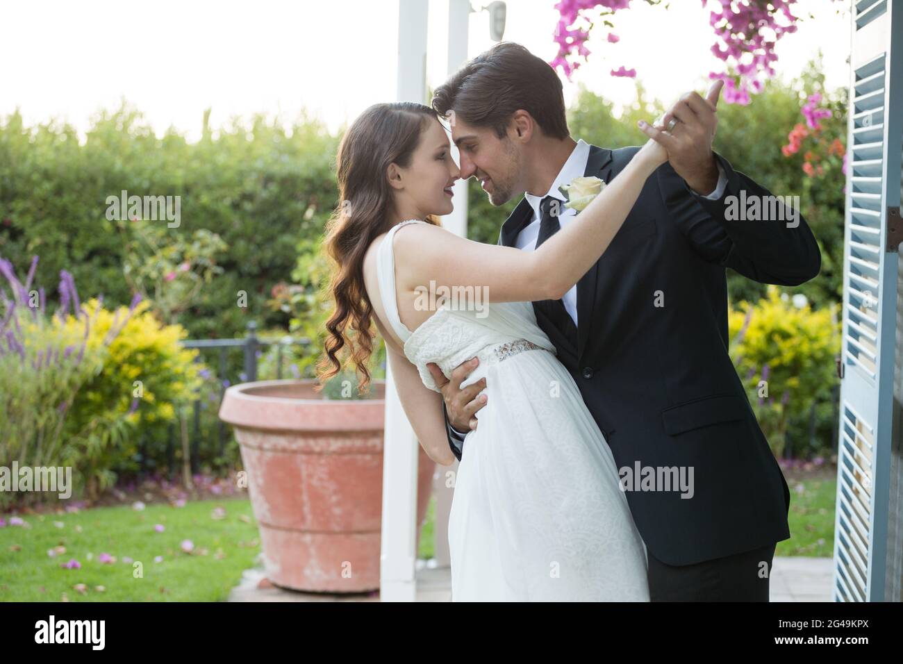 Romantic newlywed couple dancing in park Stock Photo - Alamy