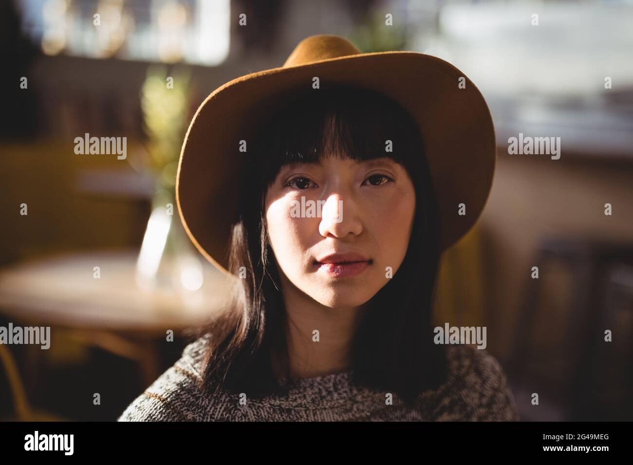 Asian woman wearing hat serious hi-res stock photography and images - Alamy