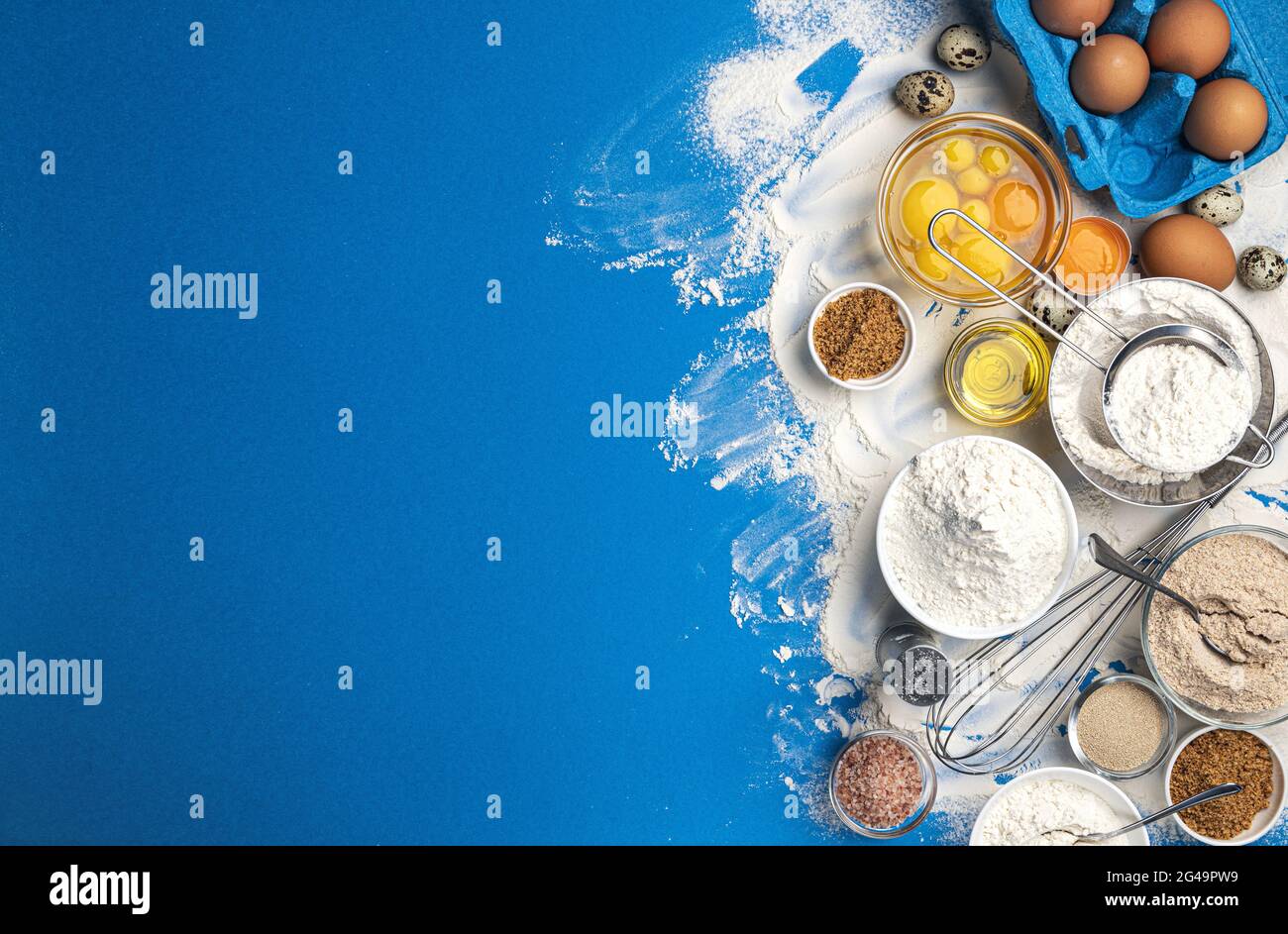 Baking ingredients on blue color background, top view Stock Photo - Alamy