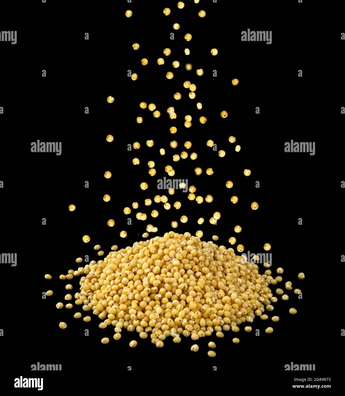 Falling dry millet grains isolated on black background Stock Photo Alamy