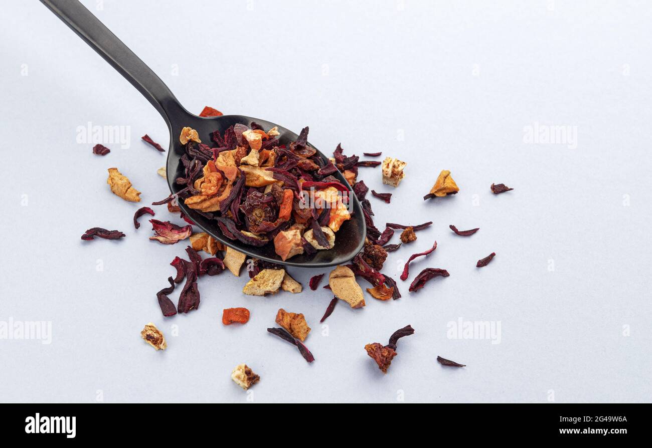 Fruit tea leaves in spoon on white background Stock Photo