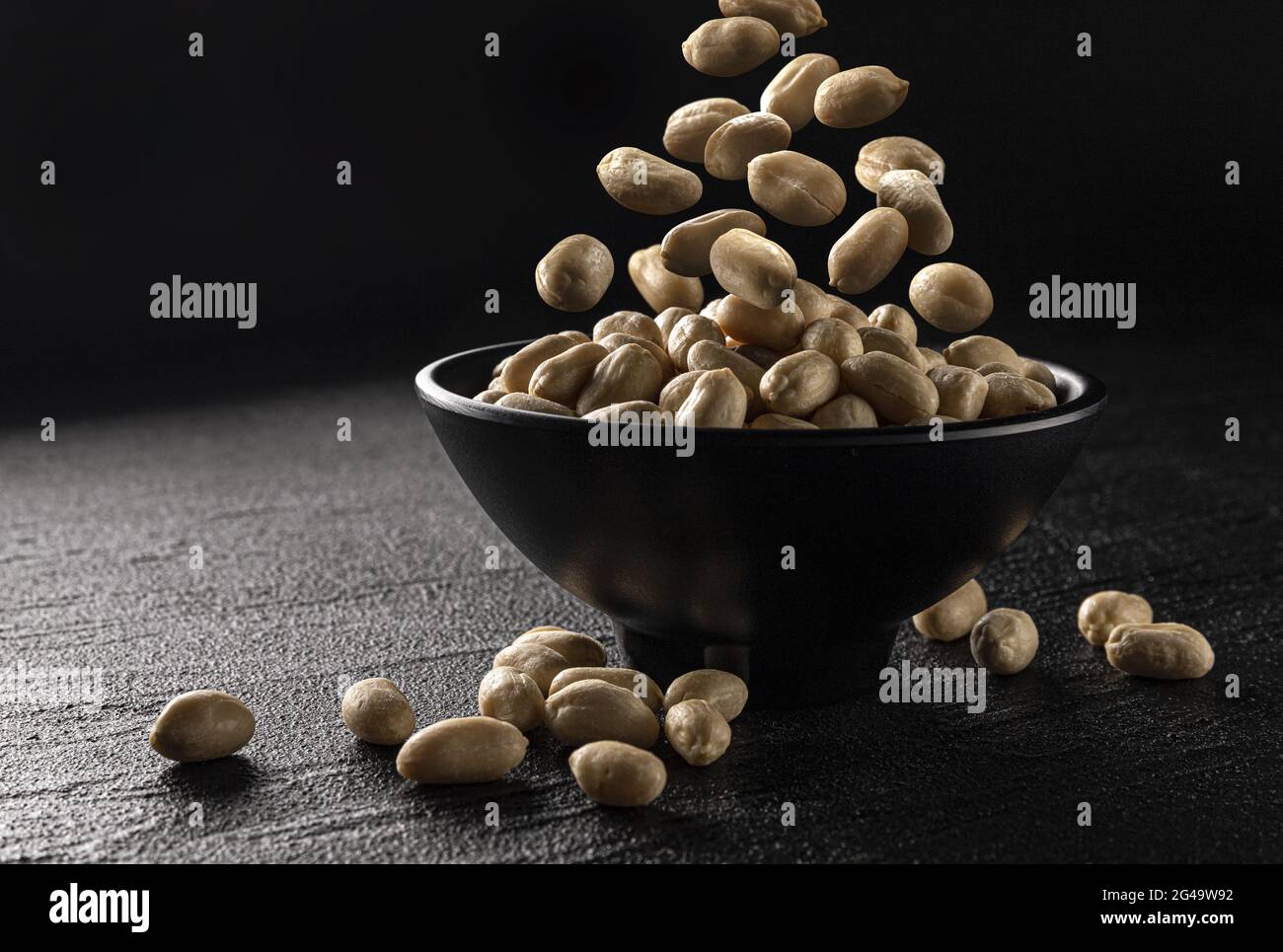 Falling peanut on black background with copy space Stock Photo
