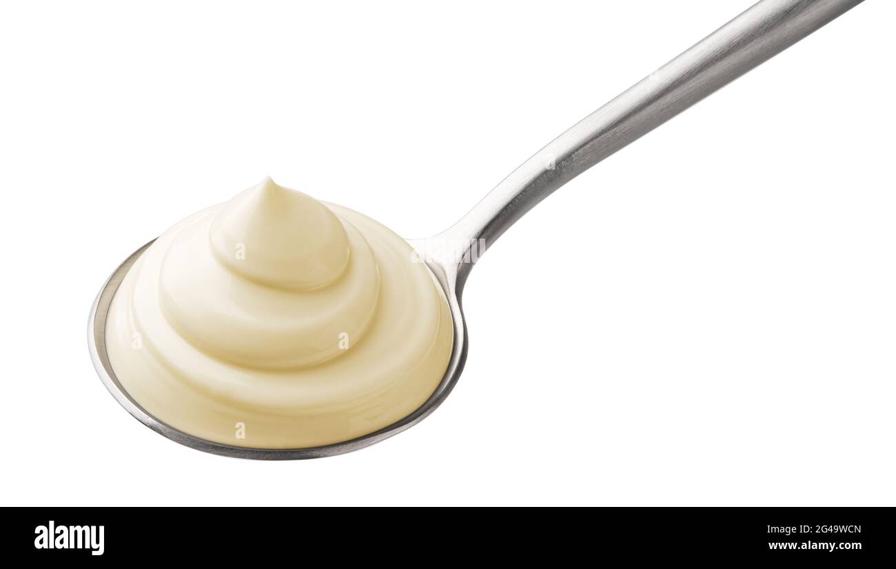 Mayonnaise in spoon isolated on white background Stock Photo