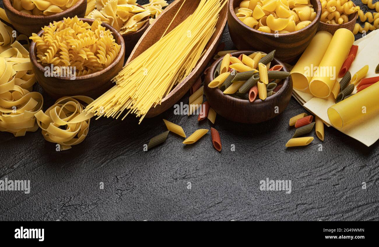 Different pasta types on black background with copy space for text Stock Photo