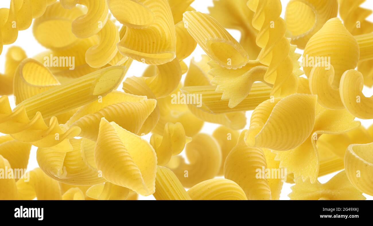 Italian pasta texture, different pasta types falling over white background Stock Photo