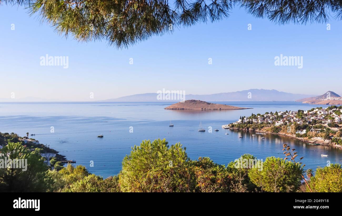 Aegean coast with marvelous blue water, rich nature, islands, mountains and small white houses Stock Photo