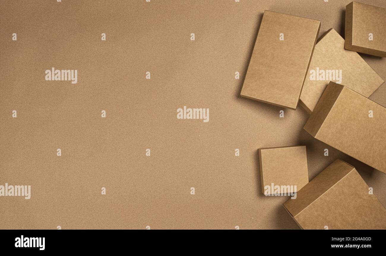 Brown cardboard boxes on craft paper background, top view Stock Photo