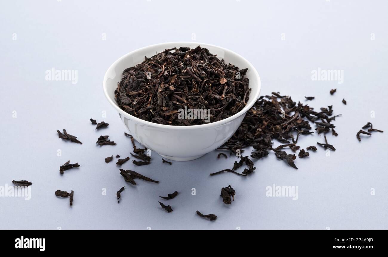 Dry black tea leaves isolated on white background Stock Photo