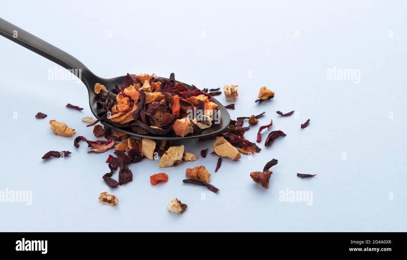 Fruit tea leaves in spoon on white background Stock Photo