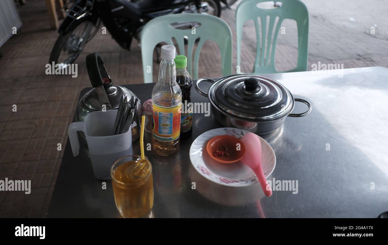 food Waiting for meal to be served condiments salt and pepper shakers Battambang Cambodia Stock Photo
