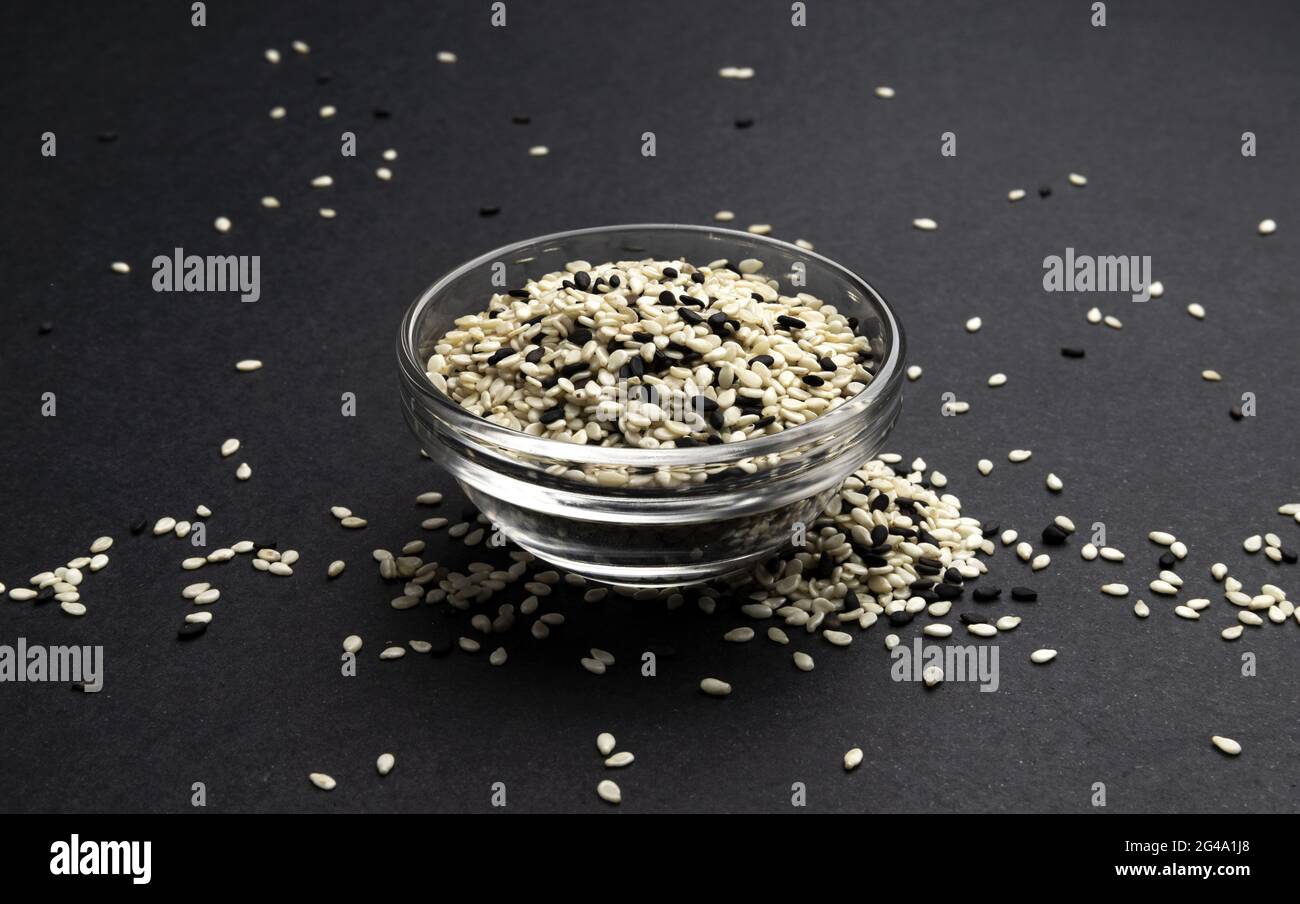 Black and white sesame seeds on black background, macro, close up Stock ...