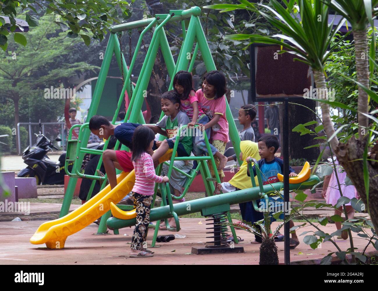 Four children playing in a playground - Stock Image - F033/7416 - Science  Photo Library