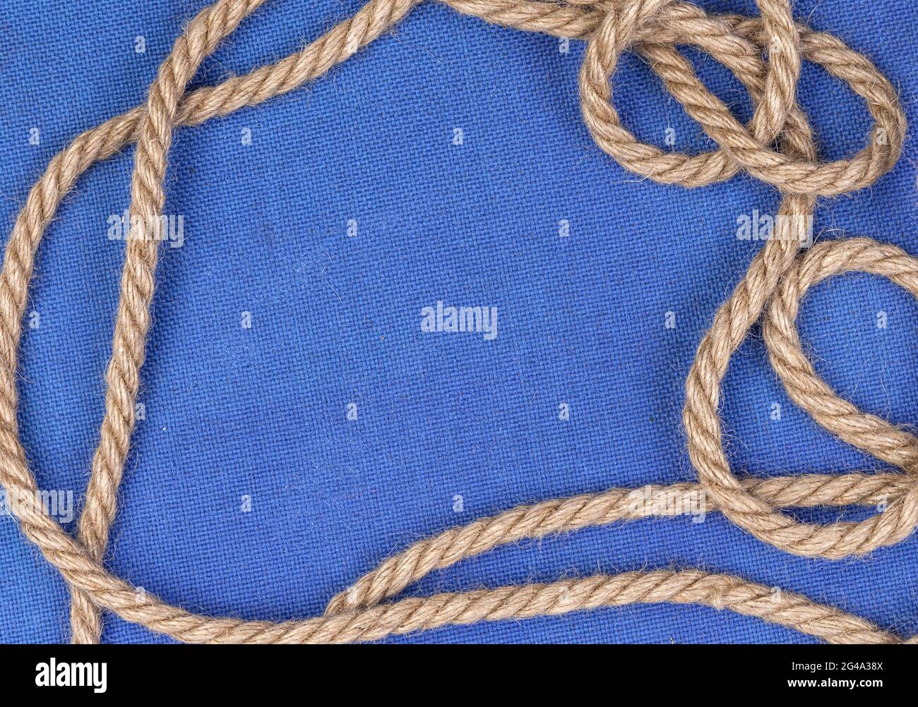 Rope on blue canvas background Stock Photo