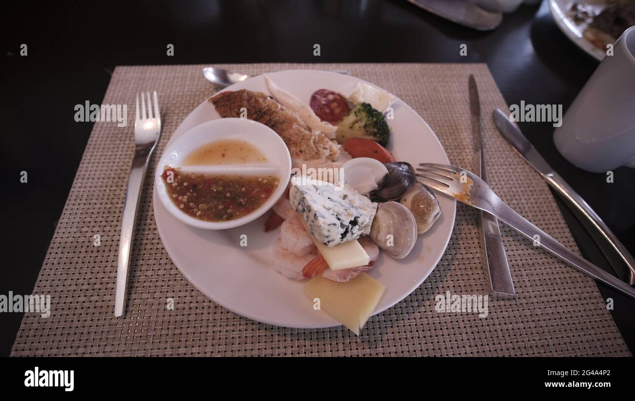 food buffet smorgasbord hotel restaurant in Pattaya Thailand all you can eat food on the table serve yourself dining utensils Stock Photo
