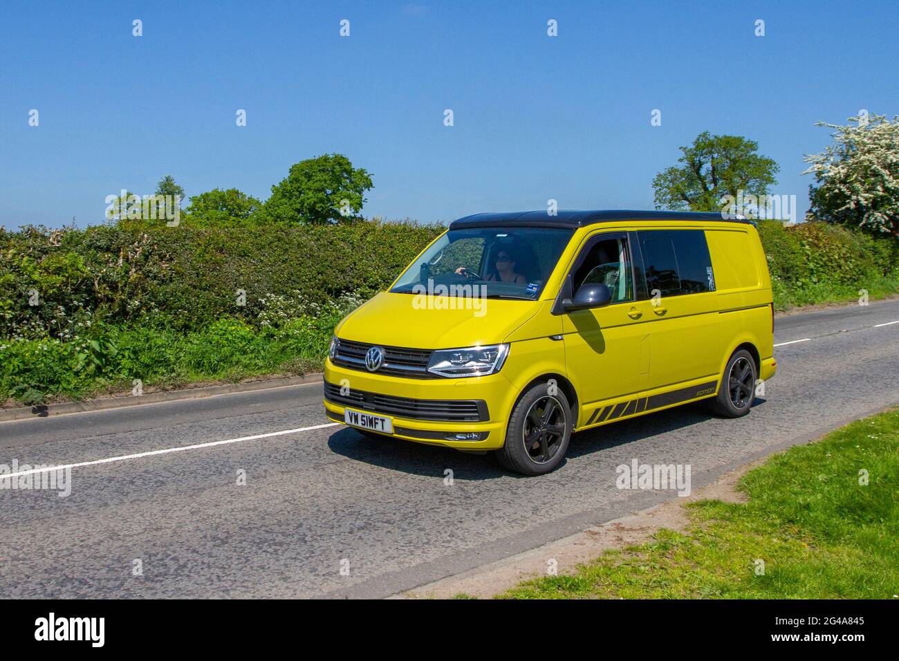 2018 yellow VW Volkswagen Transporter window van, 1968cc diesel en-route to Capesthorne Hall classic May car show, Cheshire, UK Stock Photo